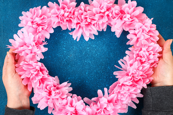 Heart shaped wreath decorated artificial flower made pink tissue paper napkins