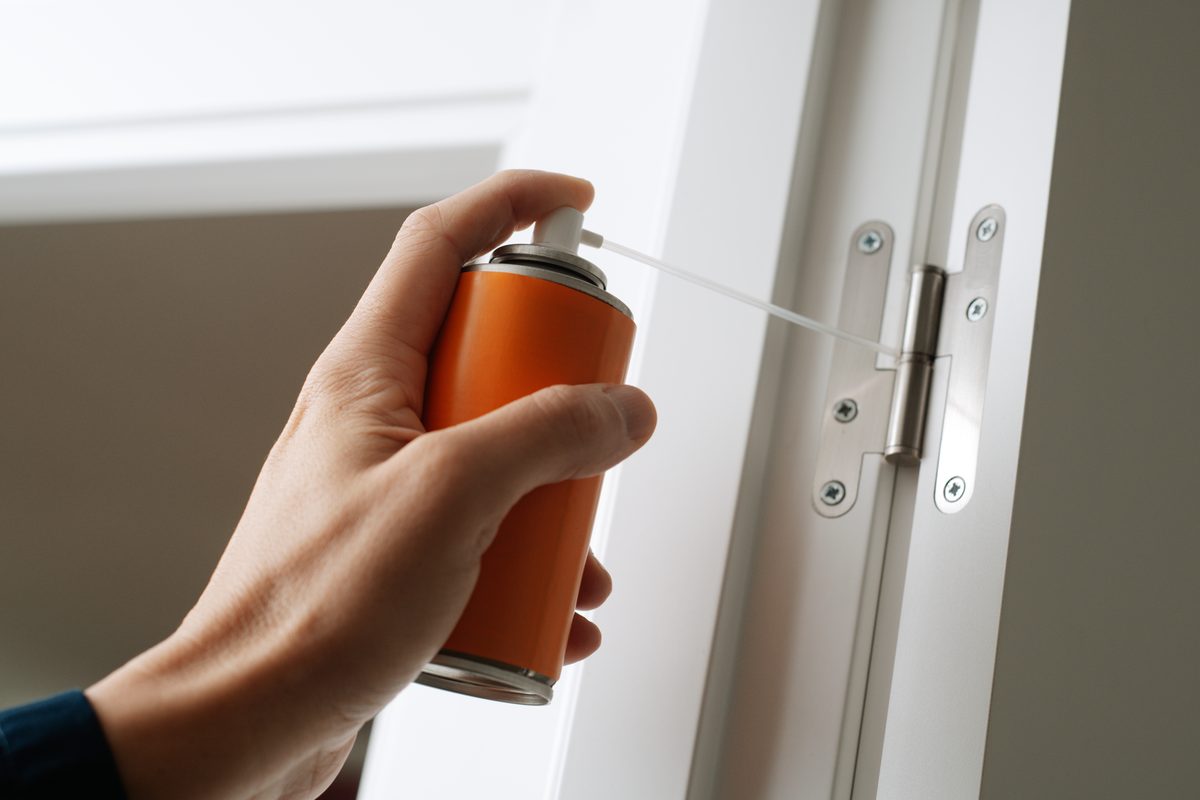 how to fix squeaky door hinges with a short burst of spray lubricant