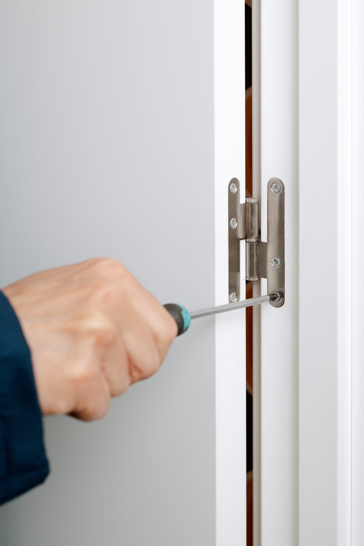 snugging loose hinge screws before treating a rubbing door edge